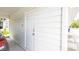 White door of the home's exterior, which is surrounded by complementary white vinyl siding at 904 Michigan Ave, St Cloud, FL 34769