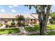 Charming brick home with a well-manicured lawn, lush landscaping, and a welcoming entrance at 904 Michigan Ave, St Cloud, FL 34769