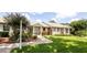 Charming brick home featuring a well-kept lawn, colorful landscaping, and a welcoming front entrance at 904 Michigan Ave, St Cloud, FL 34769
