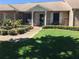 Charming single-story brick home featuring a well-manicured lawn and colorful landscaping, offering great curb appeal at 904 Michigan Ave, St Cloud, FL 34769