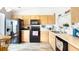 Eat-in kitchen features wood cabinets, white countertops, and black appliances at 904 Michigan Ave, St Cloud, FL 34769