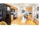 Well-equipped kitchen with wood cabinets and black appliances, ample counter space, and dining area at 904 Michigan Ave, St Cloud, FL 34769