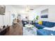 Open living room featuring hardwood floors, high ceilings, comfortable seating, and plenty of natural light at 904 Michigan Ave, St Cloud, FL 34769