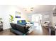 Bright living room with hardwood floors, cozy seating, stylish decor, and ample natural light at 904 Michigan Ave, St Cloud, FL 34769