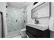 Modern bathroom featuring a sleek vanity, a spacious shower with marble tile, and contemporary fixtures at 933 Jasmine St, Celebration, FL 34747