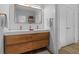 Modern bathroom featuring a double vanity with wood cabinets, and stylish fixtures, creating a spa-like atmosphere at 933 Jasmine St, Celebration, FL 34747