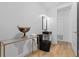 Modern bathroom with a black toilet and sink with gold accents and light wood floor at 933 Jasmine St, Celebration, FL 34747