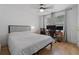 Cozy bedroom featuring a comfortable bed, hardwood floors, a ceiling fan, and a well-lit workspace at 933 Jasmine St, Celebration, FL 34747