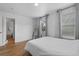 Bright bedroom with hardwood floors, a comfortable bed, and large windows offering natural light at 933 Jasmine St, Celebration, FL 34747