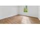 An airy bedroom with wood-look floors, white walls and a window providing natural light at 933 Jasmine St, Celebration, FL 34747