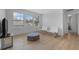Bright bonus room featuring hardwood floors, modern seating, and large windows offering natural light at 933 Jasmine St, Celebration, FL 34747