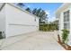 Spacious concrete driveway leading to a two-car garage, accented by manicured landscaping at 933 Jasmine St, Celebration, FL 34747