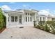 Stunning two-story home boasts large windows, elegant columns, and a welcoming front porch at 933 Jasmine St, Celebration, FL 34747