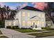 Elegant home with a well-manicured lawn, classic architecture, and a welcoming front entrance at 933 Jasmine St, Celebration, FL 34747
