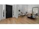 Stylish foyer featuring hardwood floors, a black front door, and elegant decor at 933 Jasmine St, Celebration, FL 34747