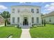 Classic two-story white home with columns, landscaped front yard, and inviting entrance at 933 Jasmine St, Celebration, FL 34747