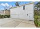 Detached two-car garage with ample driveway space and minimal landscaping around the perimeter at 933 Jasmine St, Celebration, FL 34747