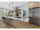Open kitchen featuring a quartz countertop island, stainless steel appliances, and bar stool seating at 933 Jasmine St, Celebration, FL 34747