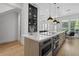 Modern kitchen island featuring stainless steel appliances and a quartz countertop at 933 Jasmine St, Celebration, FL 34747