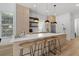 Modern kitchen with stainless steel appliances, white countertops, and stylish bar seating at 933 Jasmine St, Celebration, FL 34747