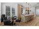 Modern kitchen and dining area with stainless steel appliances, an island with bar seating, and a dining table at 933 Jasmine St, Celebration, FL 34747
