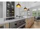 Modern kitchen with a large island, stainless steel appliances, and stylish pendant lighting at 933 Jasmine St, Celebration, FL 34747