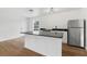 Well-lit kitchen with granite countertops, sleek appliances, and a stylish island, creating a functional space at 933 Jasmine St, Celebration, FL 34747