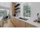 Kitchen featuring a stainless steel sink and faucet, floating shelves, and bright natural light at 933 Jasmine St, Celebration, FL 34747