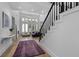 Bright living room with large windows and a staircase featuring black and white accents at 933 Jasmine St, Celebration, FL 34747