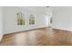 Bright living room with natural light and wood flooring, providing a welcoming and airy ambiance at 933 Jasmine St, Celebration, FL 34747