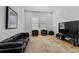 Cozy living room featuring a black leather sofa and modern furnishings at 933 Jasmine St, Celebration, FL 34747