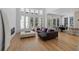 Spacious living room with large windows, a modern sofa, and an adjacent dining area at 933 Jasmine St, Celebration, FL 34747