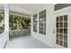 Charming porch featuring white trim, large windows, and an entry door at 933 Jasmine St, Celebration, FL 34747