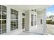 Covered porch with white trim, large windows, and entry door showcasing natural light at 933 Jasmine St, Celebration, FL 34747