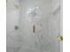 Luxurious shower featuring marble tile, gold hardware, a circular window, and a modern design at 933 Jasmine St, Celebration, FL 34747
