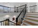 Interior staircase with wood treads, black metal railing, and natural light at 933 Jasmine St, Celebration, FL 34747