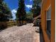 Spacious brick patio with outdoor seating, mature trees, and fenced yard create a private retreat at 10207 Cody Ln, Orlando, FL 32825