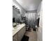 Bathroom with sink, vanity, gray-toned shower curtain and a modern mirror at 10207 Cody Ln, Orlando, FL 32825