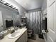 Bathroom with sink, vanity, gray-toned shower curtain and a modern mirror at 10207 Cody Ln, Orlando, FL 32825