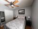 Bedroom featuring a wooden floor, ceiling fan, and window providing natural light at 10207 Cody Ln, Orlando, FL 32825