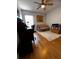 This bedroom features a ceiling fan, sofa, hardwood floors, area rug, and natural light at 10207 Cody Ln, Orlando, FL 32825