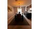 This spacious dining room features a modern chandelier, a dark wood table, and beautiful artwork on the walls at 10207 Cody Ln, Orlando, FL 32825