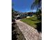Long driveway leading to a house with well-maintained lawn, garden, and additional parking at 10207 Cody Ln, Orlando, FL 32825
