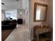 This entryway features a decorative mirror and leads to the living room with tile flooring at 10207 Cody Ln, Orlando, FL 32825