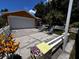 Charming home with an attached two-car garage, front lawn, garden, and seating at 10207 Cody Ln, Orlando, FL 32825