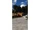 Residential home featuring a well-manicured lawn and landscaped garden with mature trees and a long driveway at 10207 Cody Ln, Orlando, FL 32825