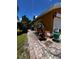 Side exterior view of home with lush landscaping, decorative elements, and brick pathway at 10207 Cody Ln, Orlando, FL 32825