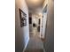 Hallway with wood-look tile flooring and stylish decor leading to other rooms in the home at 10207 Cody Ln, Orlando, FL 32825