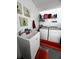 Bright laundry room features a utility sink with white cabinets and modern washer and dryer set at 10207 Cody Ln, Orlando, FL 32825