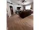 This living room features a ceiling fan, a large TV, and light wood-look tile floors at 10207 Cody Ln, Orlando, FL 32825